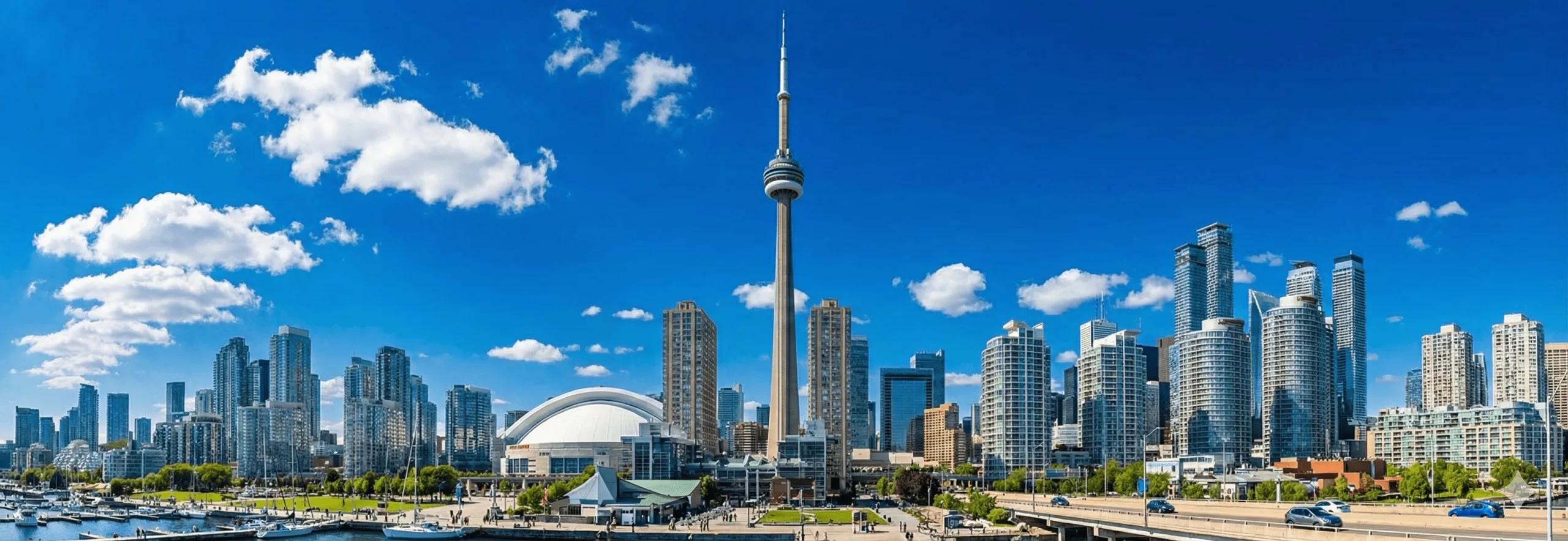 Toronto Downtown Car Rentals with city skyline and CN Tower waterfront view.