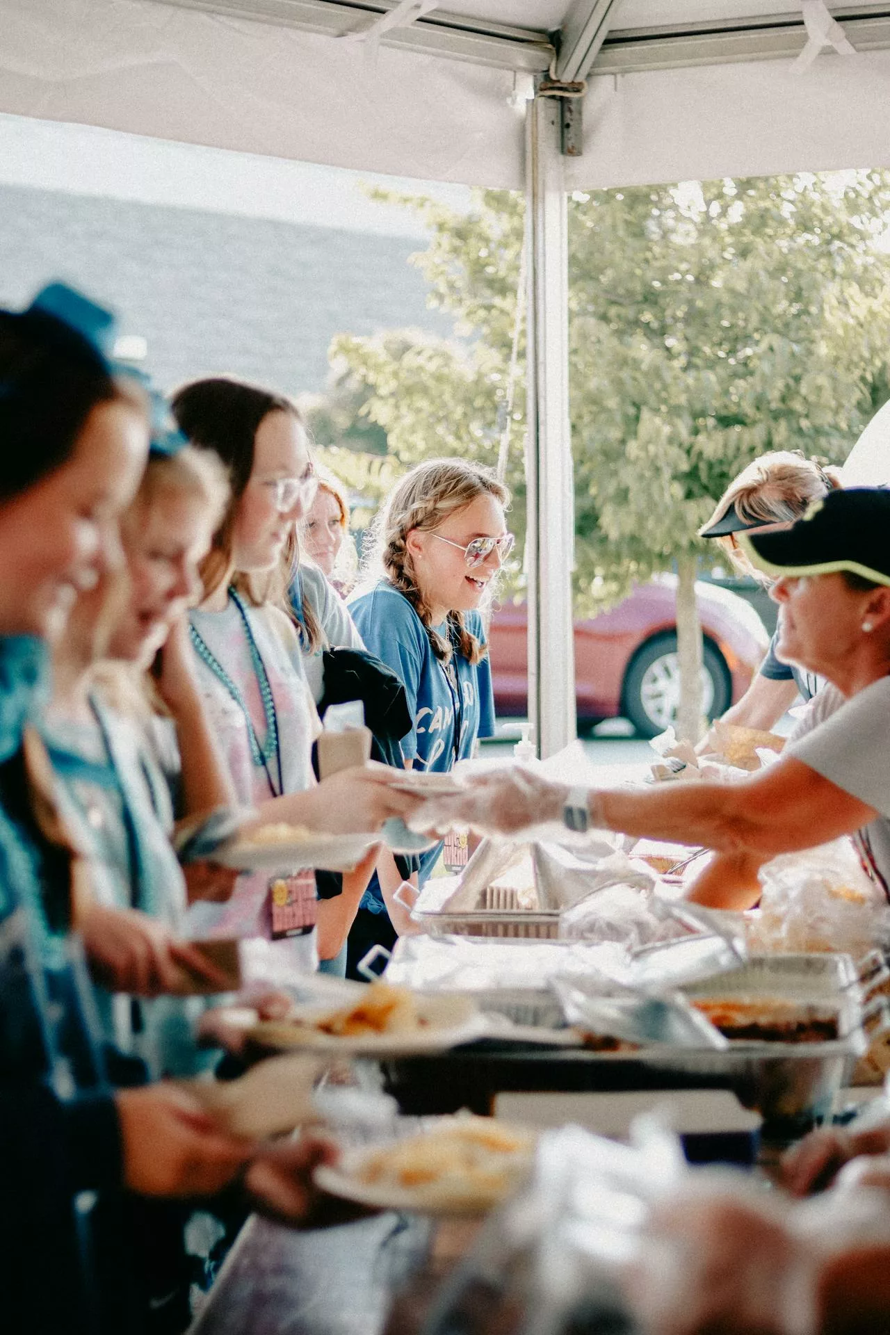 People enjoying food at a festival in Vancouver, Canada. Renting a car is suggested.