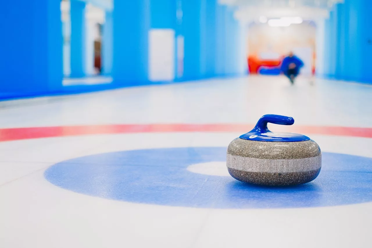 World Women's Curling Championship 2026 poster with curling stone on the ice and event details.