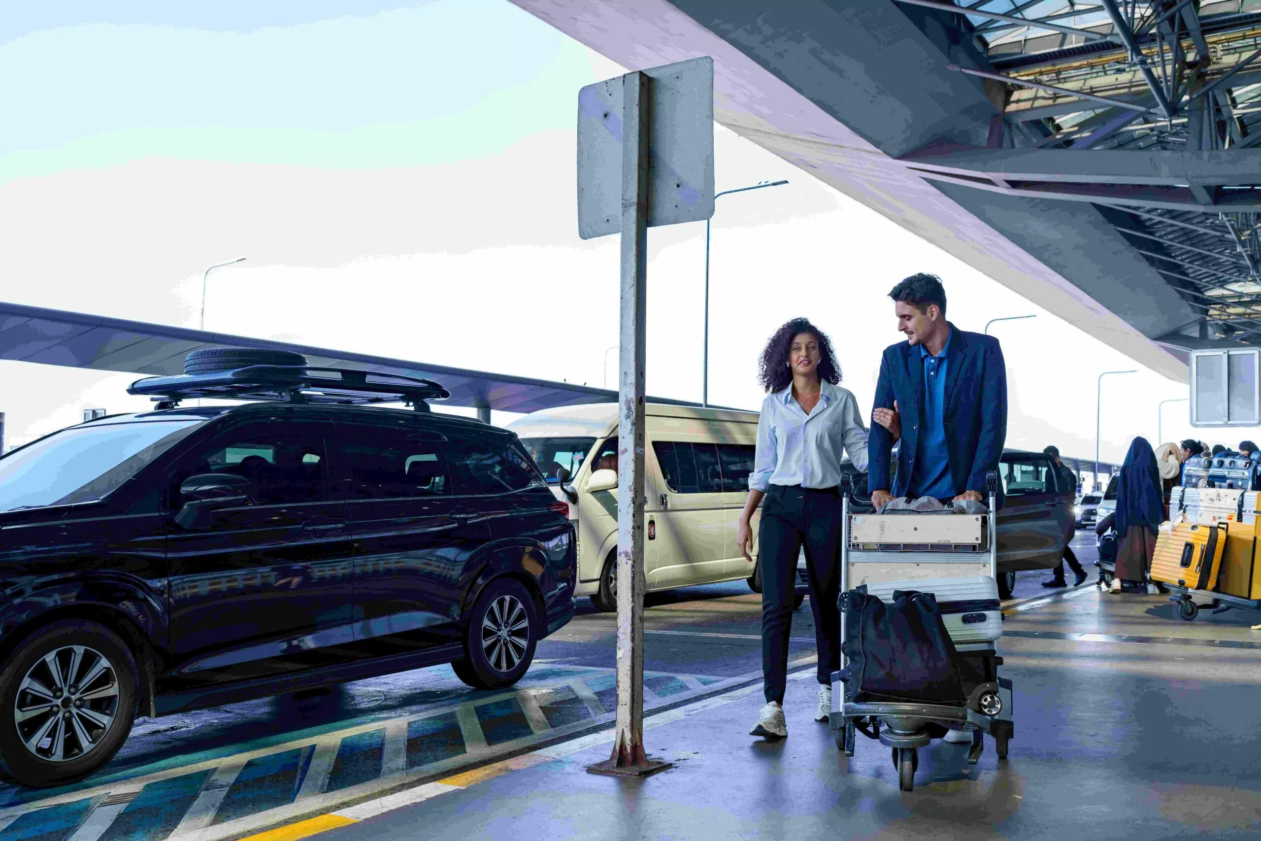International visitors collecting a premium SUV rental near Calgary International Airport with luggage for a Canada road trip