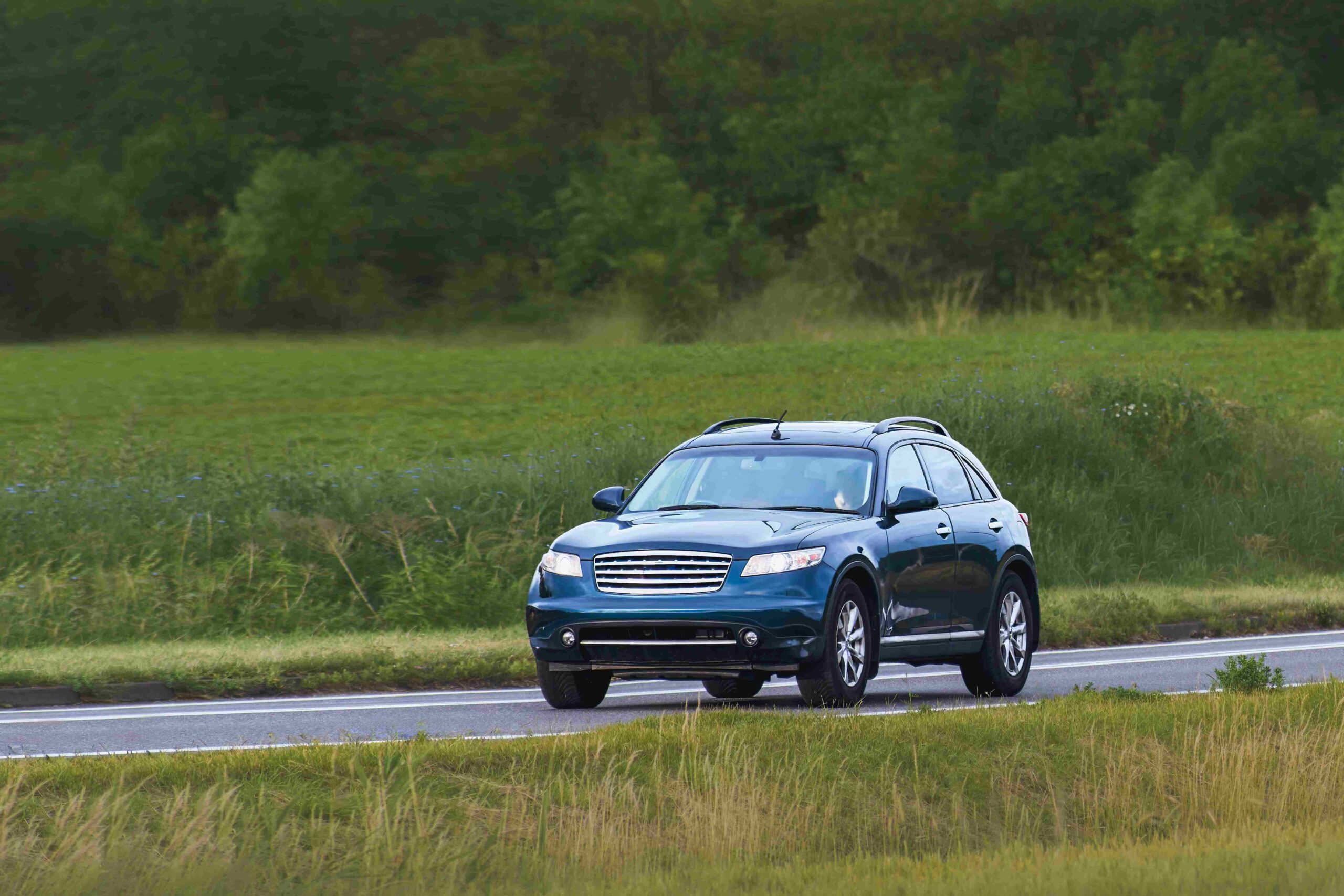 Vancouver airport car rental SUV driving through scenic British Columbia countryside during a road trip adventure
