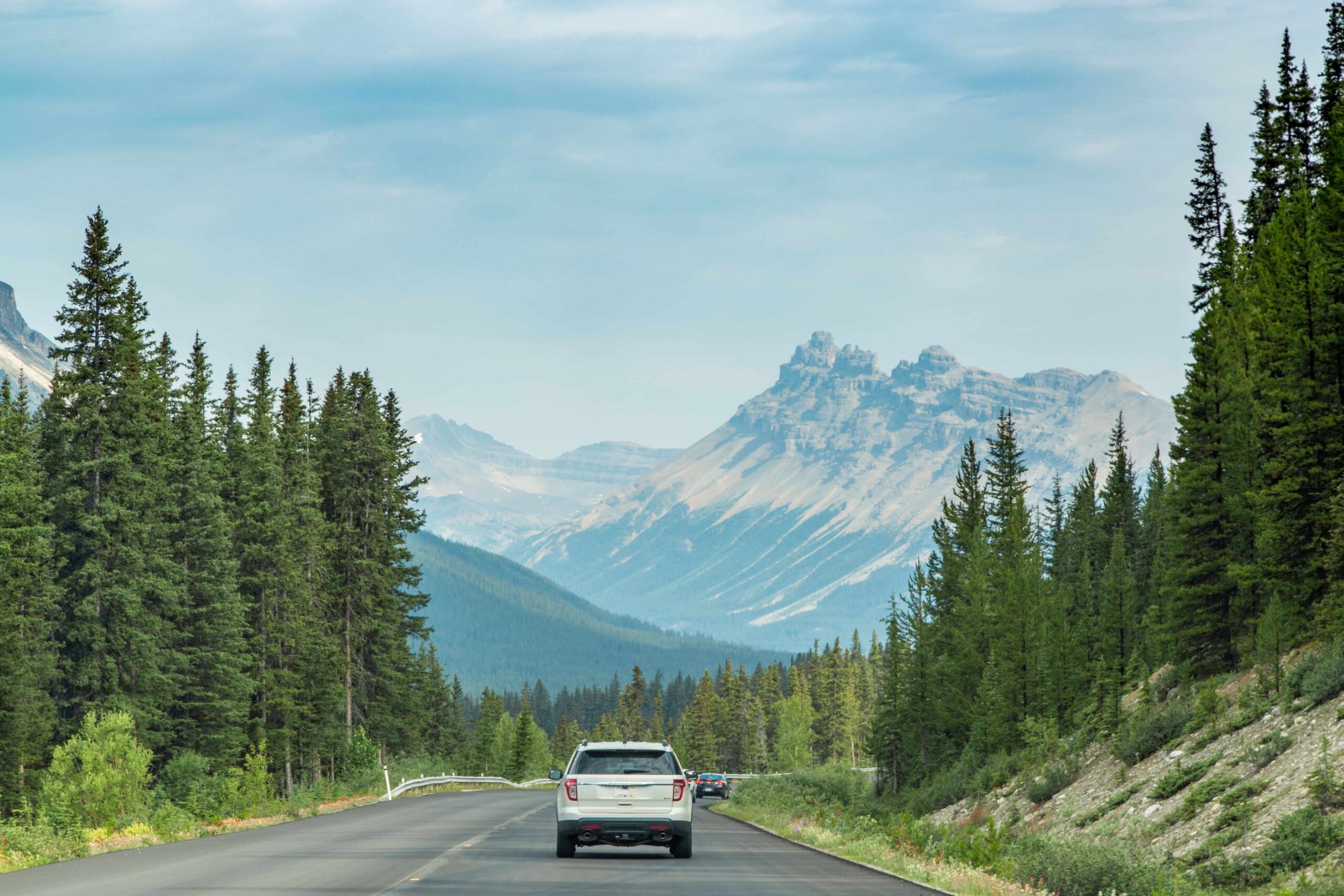 SUV rental Calgary vehicle driving through Banff National Park and the Canadian Rockies in 2026