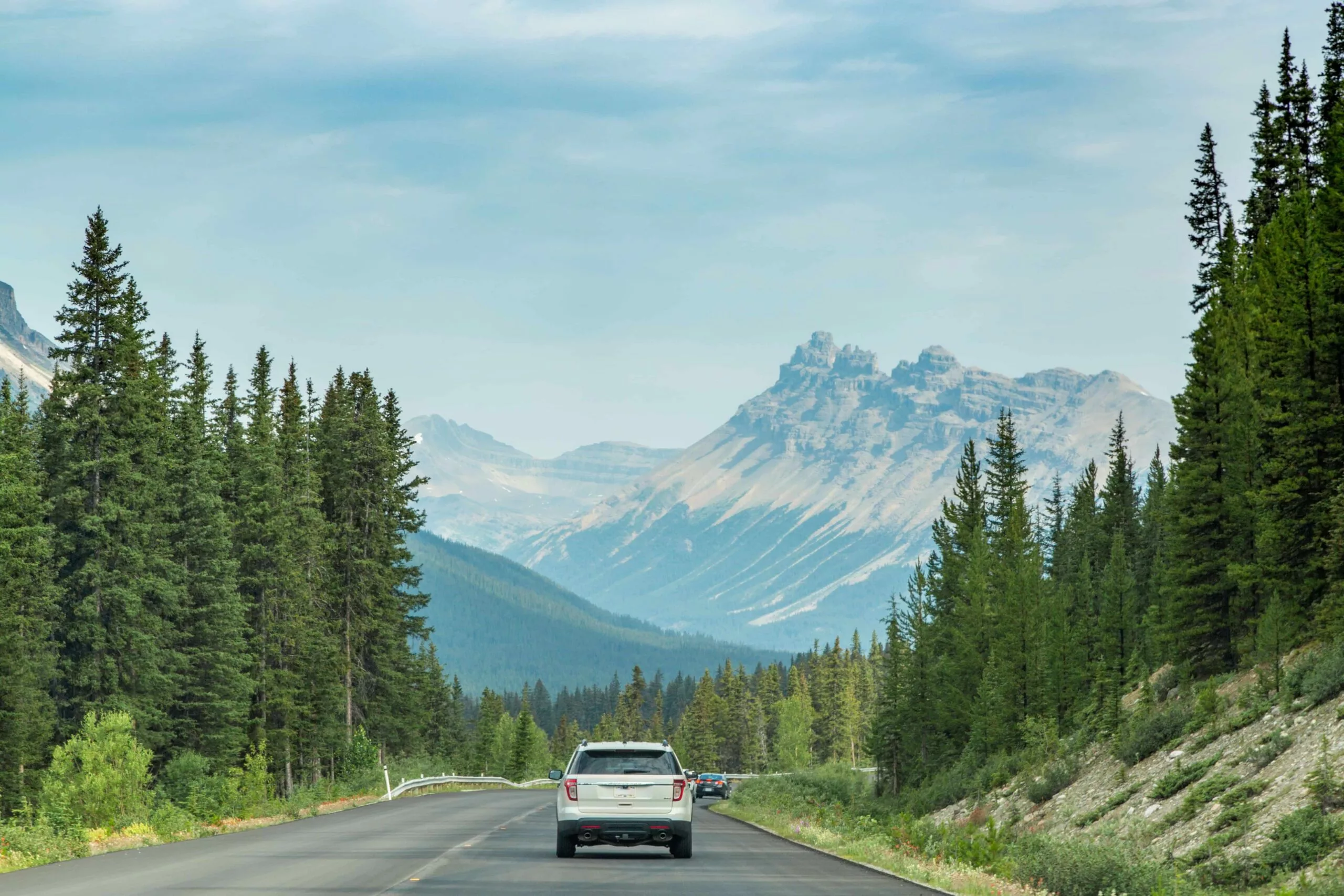 SUV rental Calgary vehicle driving through Banff National Park and the Canadian Rockies in 2026