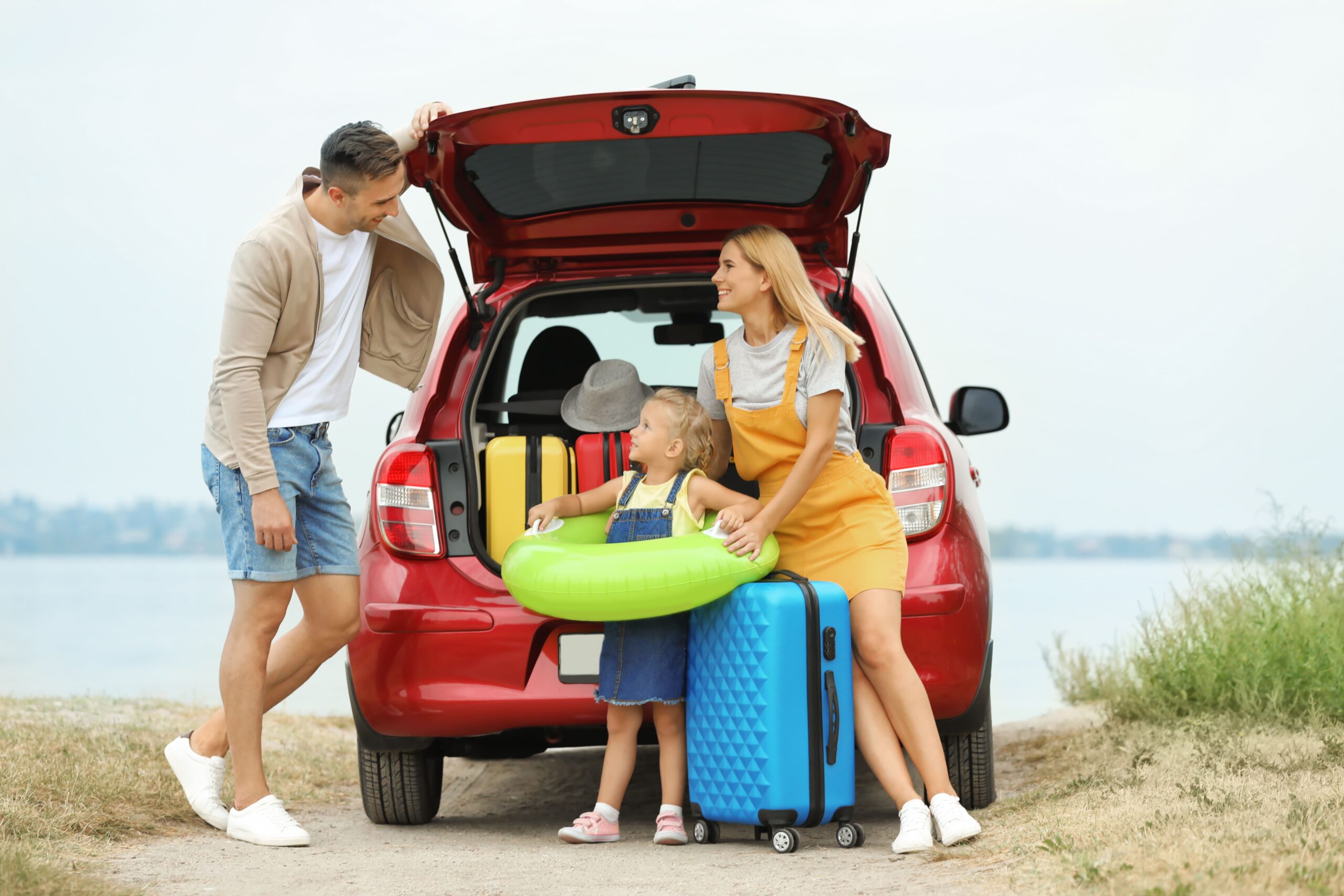 AA family loading snorkel gear and coolers into an SUV at an Aruba beach, highlighting why a spacious car rental Aruba SUV suits group and family travelers