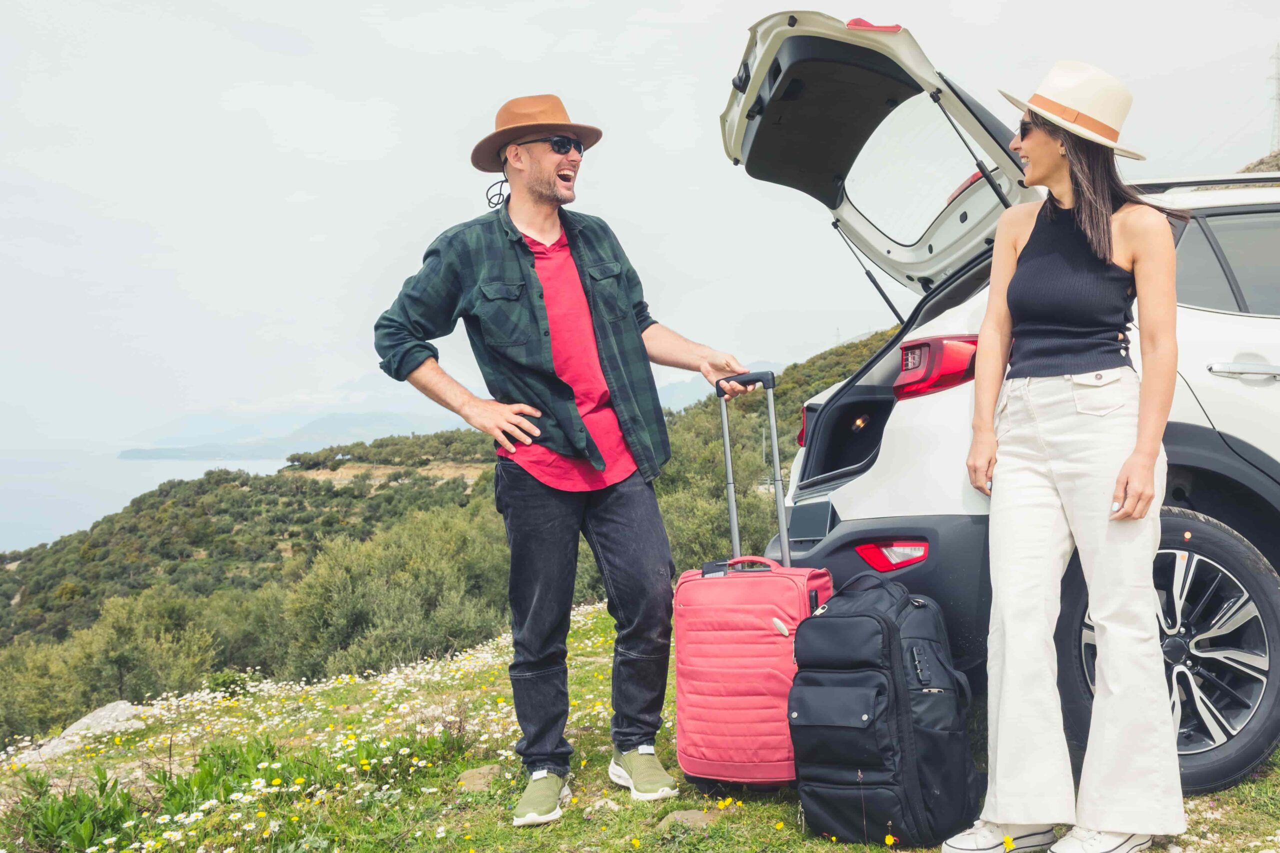 Summer road trip car rental with family loading luggage into an SUV