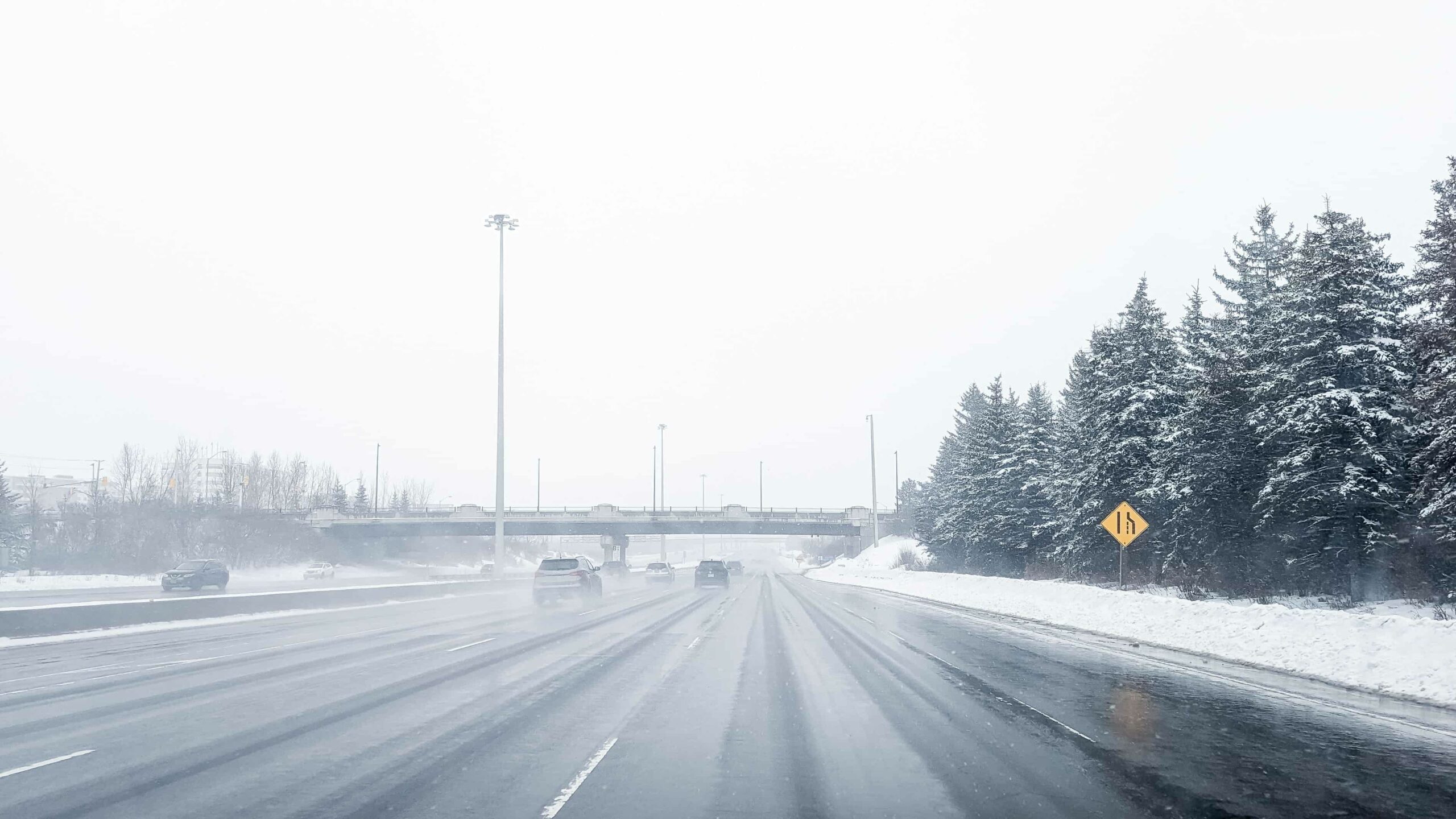Winter car rental Canada driving safely on icy Ontario highways during snowfall