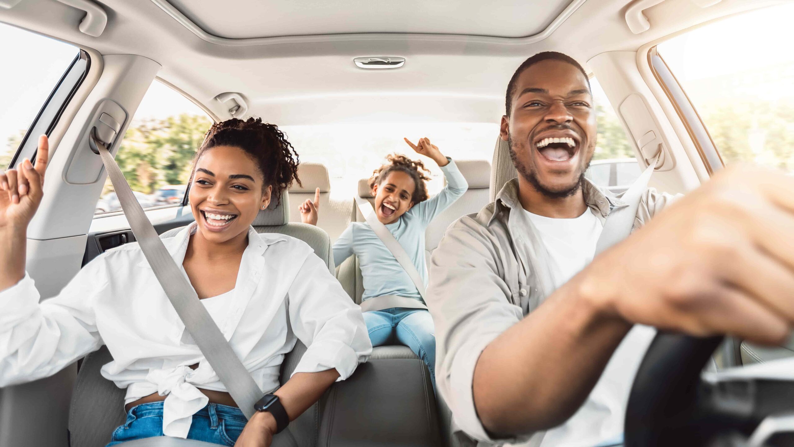 Summer road trip car rental with SUV driving along a scenic North American highway