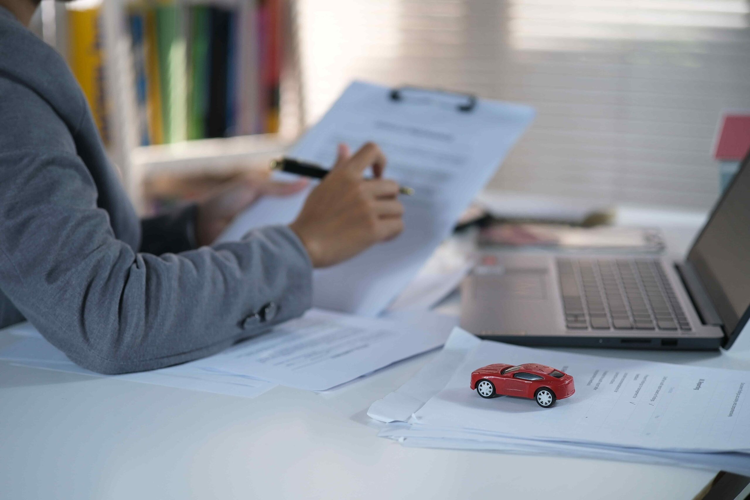 Car rental insurance guide showing a customer reviewing rental coverage at the counter