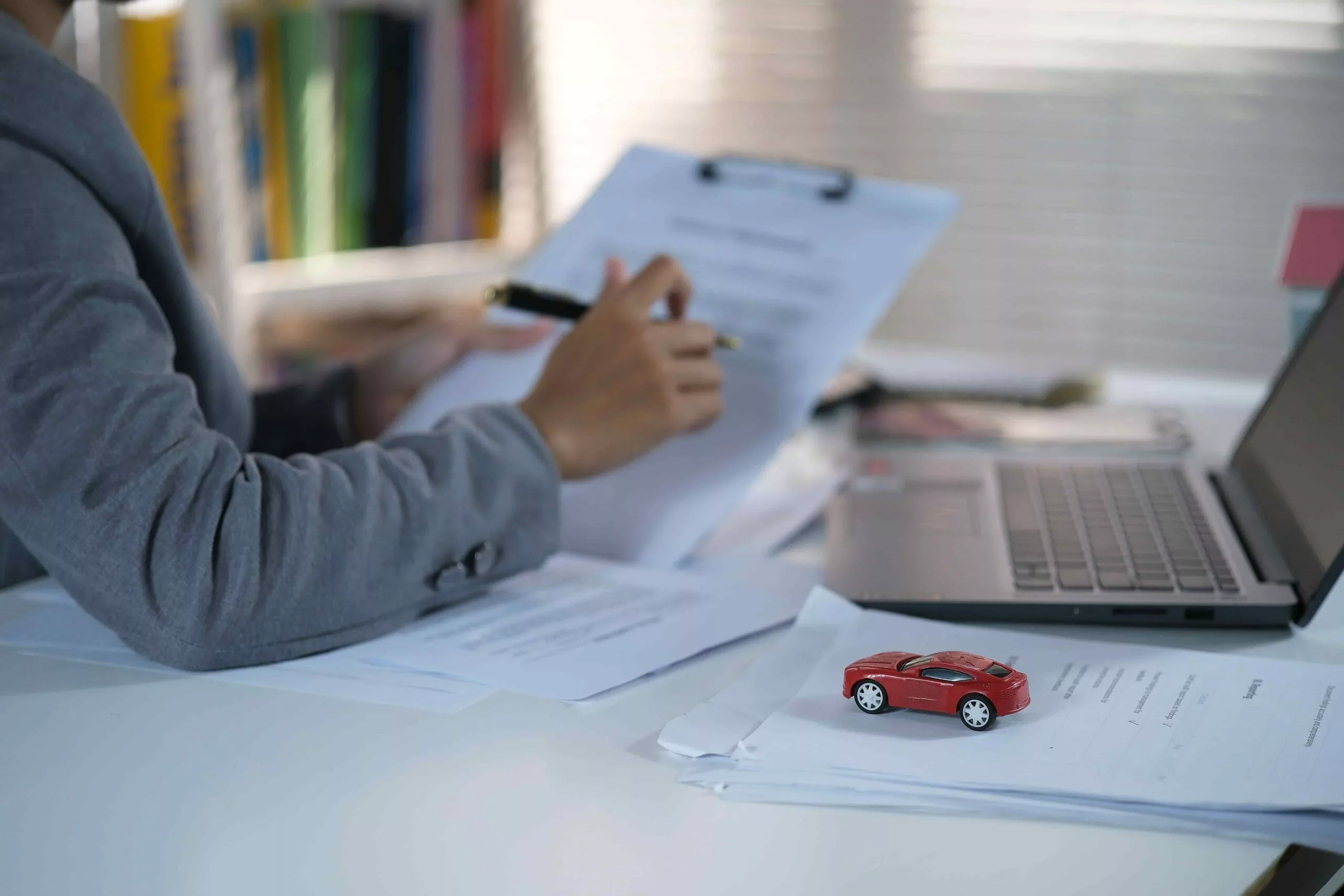 Car rental insurance guide showing a customer reviewing rental coverage at the counter
