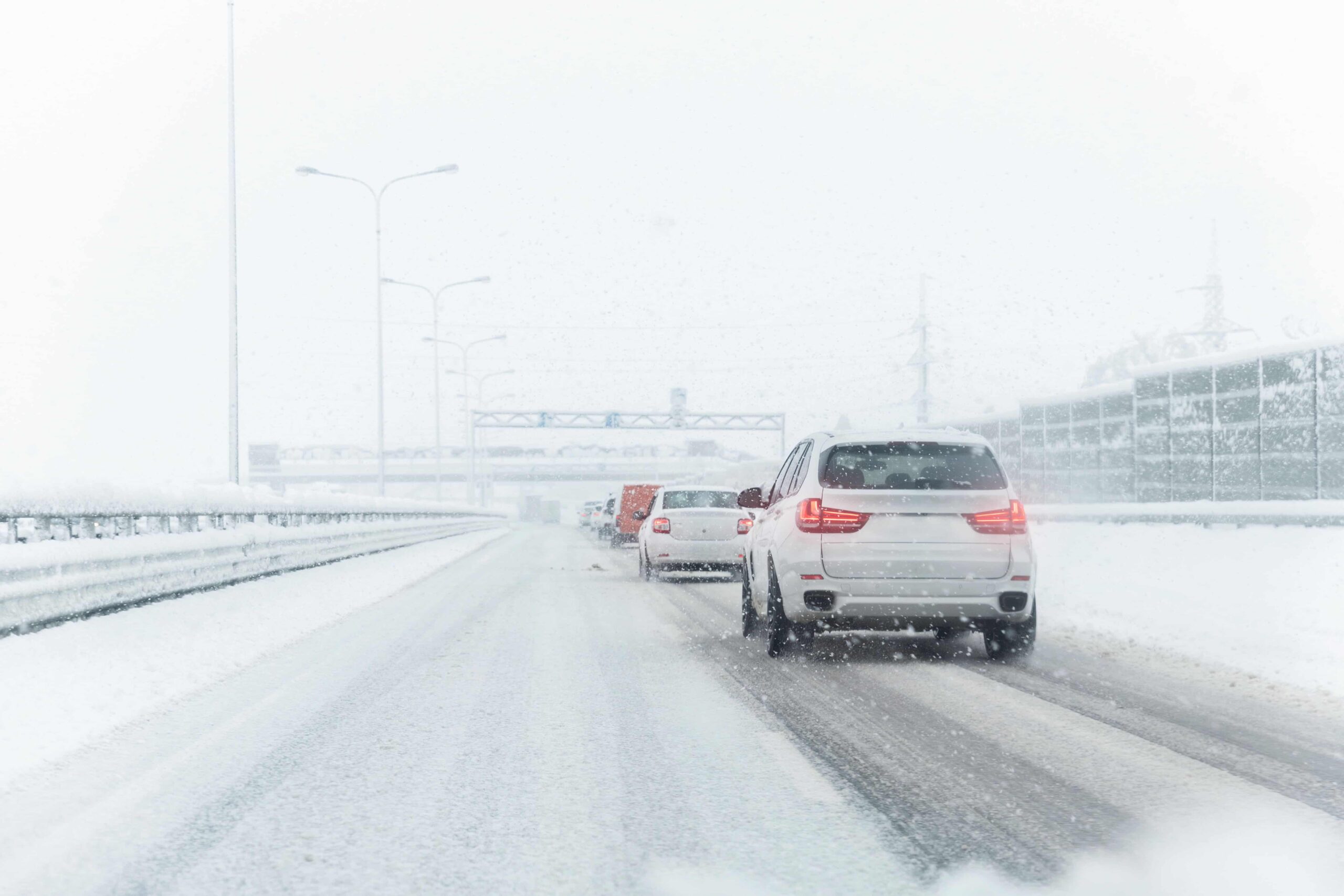 Winter car rental Canada with SUV driving safely on a snow-covered Canadian highway
