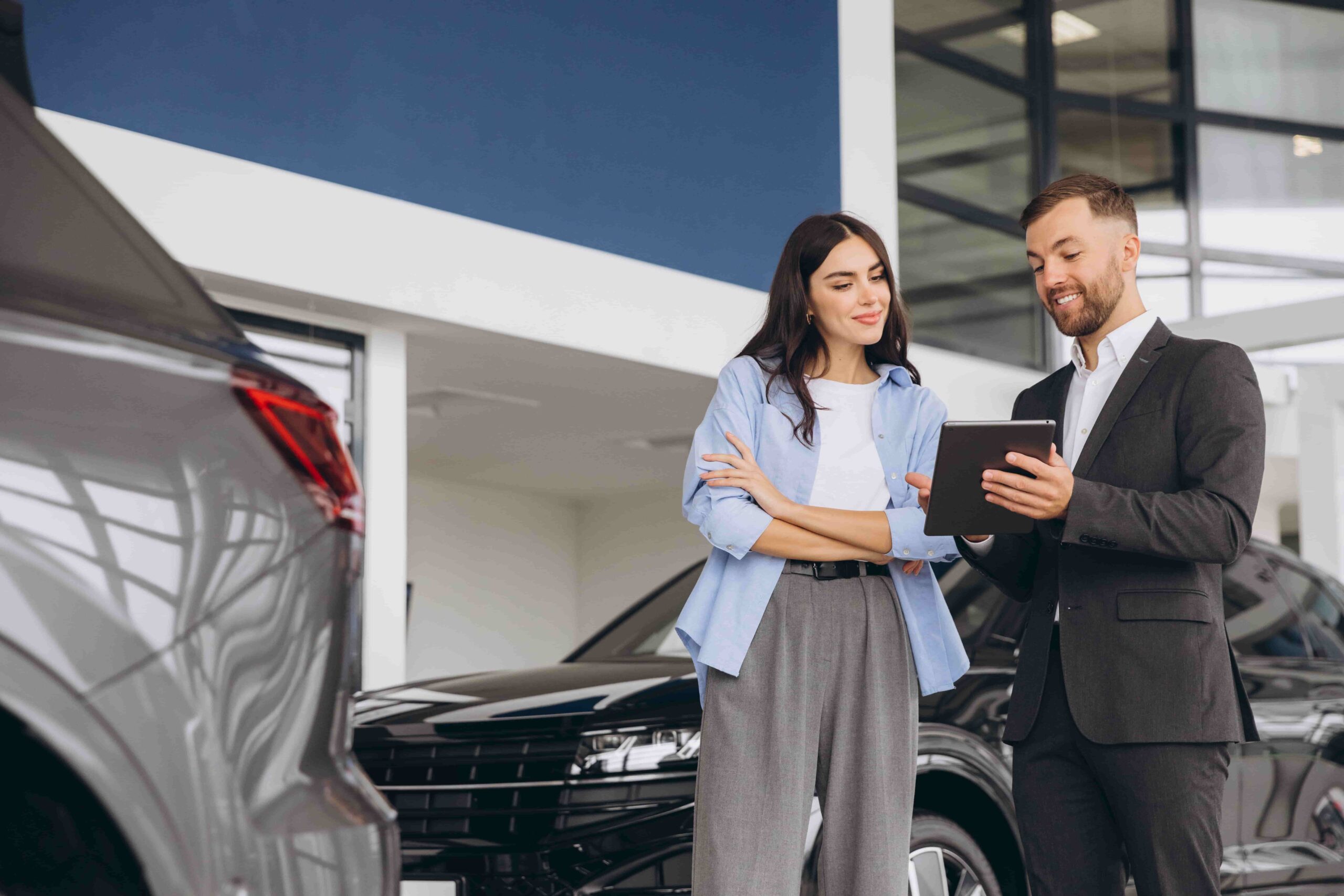 Traveler working with a car rental agent to find an alternative vehicle during peak season