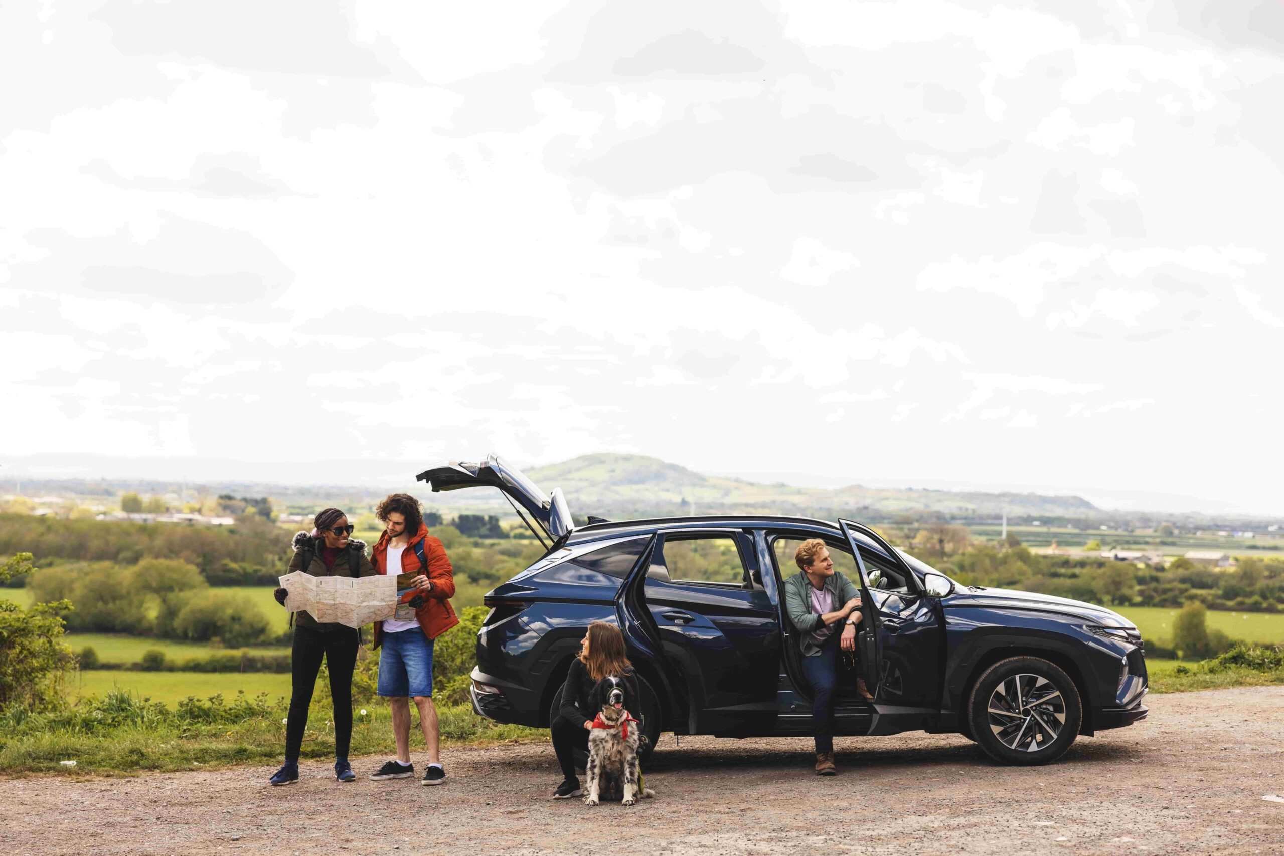 Family of five choosing a rental car with comfortable seating and luggage space